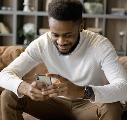 A men who smile in front of his phone